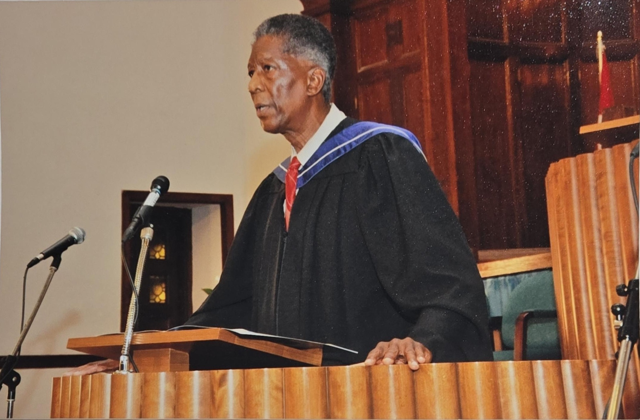Speaking picture of Roy H Pierce at a graduation service.